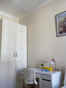 a bedroom with a desk and a white cabinet at Lovely Private Rooms in Camden, Central London in London