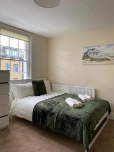 a bedroom with a large bed and a window at Lovely Private Rooms in Camden, Central London (8) in London