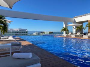 a swimming pool on the roof of a building at Grand Luxxe with free Golf in Nuevo Vallarta 