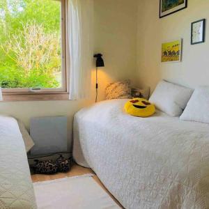 a bedroom with a bed with a pumpkin pillow on it at COZY HOLIDAY HOME by the sea in Yderby