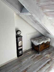 a attic room with a bench and a clock at Ferienwohnung Alex Mayer in Langenargen