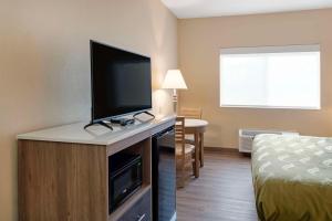 a hotel room with a flat screen tv on a cabinet at Quality Inn Bemidji in Bemidji