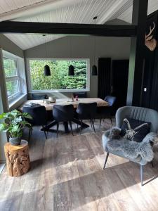 a living room with a table and chairs and a dining room at Ferienhaus Bergwild in Winterberg