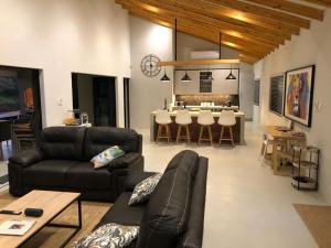 a living room with a couch and a table at Modern Bush Living in Marloth Park