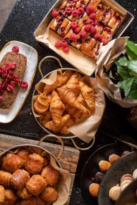a table topped with plates of pastries and bread at Radisson Blu Hotel Wroclaw in Wrocław