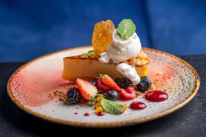 a dessert with fruit and ice cream on a plate at Radisson Blu Hotel Wroclaw in Wrocław +95 photos
