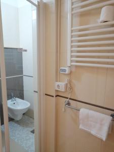 a small bathroom with a sink and a toilet at Hotel Cuba Aeroport Restaurant in Rimini