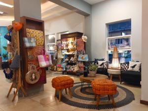 a store with chairs and a table in a room at Hotel Sriti Magelang in Magelang