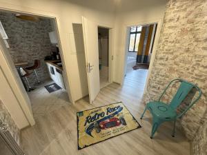 a room with a blue chair and a book on the floor at DESIGN Apartment III - 35qm Grenze Altstadt Park in Görlitz