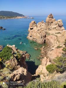 an aerial view of a rocky shore with the ocean at Casa Flo in Viddalba