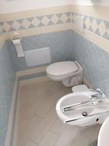 a bathroom with a toilet and a sink at Casa Flo in Viddalba +17 photos