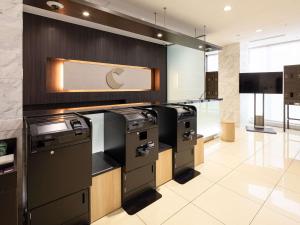 an apple kitchen with black appliances in a room at Comfort Inn Nagoya Sakae in Nagoya