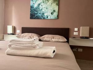 two towels are stacked on a bed in a room at Roma Suite Trastevere Railway Station in Rome