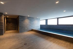a empty room with a swimming pool in a building at Isard Homes by Select Rentals in El Tarter