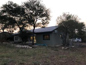 a house with a car parked in front of it at Modern Bush Living in Marloth Park