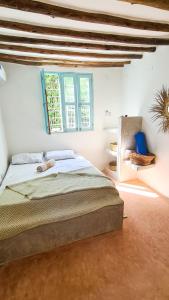 a bedroom with a large bed and a window at Yasmin house in Kizimkazi