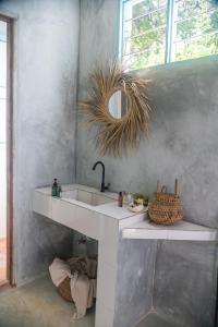 a bathroom with a sink and a mirror at Yasmin house in Kizimkazi