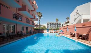 a swimming pool in the middle of a building at Hotel San Marco in Alghero