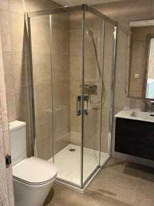 a bathroom with a shower with a toilet and a sink at La Cala de Mijas Apartment in Málaga