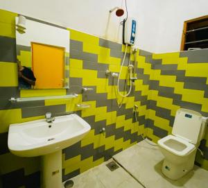a bathroom with a sink and a toilet at Happy Resort Yala in Tissamaharama