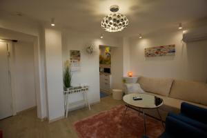 a living room with a couch and a table at Apartments Panorama in Veliko Tŭrnovo