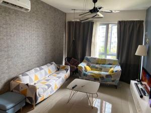 a living room with a couch and a table at Condo in Klang. Nordica Gravit8 in Klang