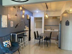 a kitchen and dining room with a table and chairs at Condo in Klang. Nordica Gravit8 in Klang