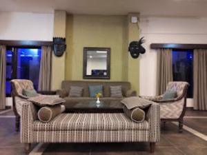 a living room with a couch and two chairs at MPT Jungle Camp, Panna in Rājgarh