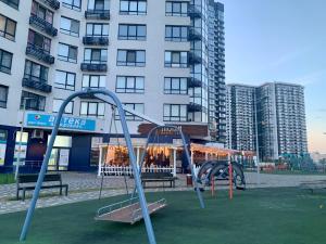 an empty playground in a city with buildings at 4 rooms apartment with a view of the Dnieper River in Kyiv