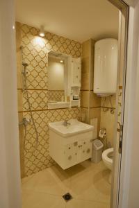 a bathroom with a sink and a toilet at Apartments Panorama in Veliko Tŭrnovo