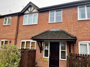 a red brick house with a black door at Pass the Keys Modern Family Friendly Flat with Parking in Rickmansworth