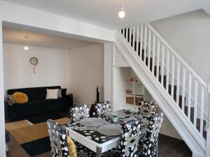 a dining room with a table and chairs at Bright Spacious Twin Room, next to Underground Station in Abbey Wood