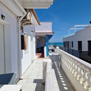 a balcony with a view of the ocean at Hostal Alba in La Mata