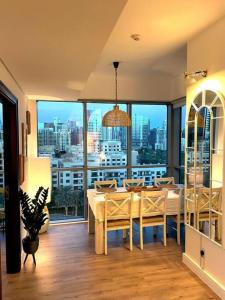a dining room with a table and a view of a city at Lakeside Bliss Home in Dubai