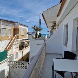 a balcony of a house with a table and chairs at Hostal Alba in La Mata