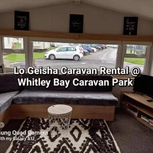a room with a basketball hoop in a parking lot at Lo Geisha Caravan Rental at Whitley Bay Caravan Park in Whitley Bay