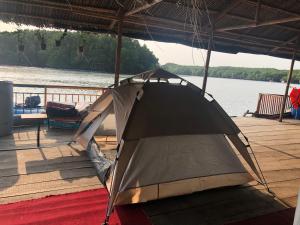 a tent sitting on the deck of a boat at Cần Giờ Floating House in Ấp Phước Thới