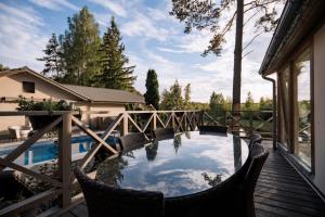 a deck with chairs and a swimming pool on a house at Silene Resort & Spa in Silene