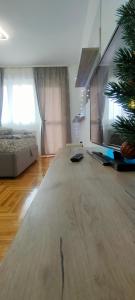 a living room with a couch and a christmas tree at Apartman Ema in Valjevo