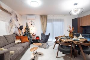 a living room with a couch and a christmas tree at Apartman Joe in Virovitica