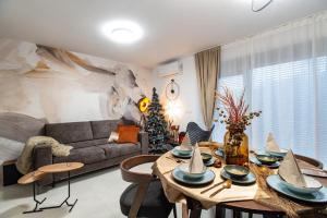 a living room with a table and a couch at Apartman Joe in Virovitica