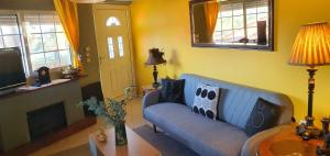 a living room with a blue couch and a table at VELANIDIA HOUSE in Rafina