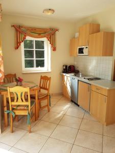 a kitchen with a table and a table and a window at Ehrentaler Ferienhaus GbR in Schmalkalden +12 photos