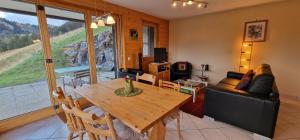a living room with a wooden table and a couch at Majis 4 in Champoussin