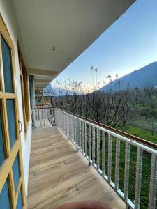 a balcony with a view of the mountains at Cloud 9 Chalet in Manāli