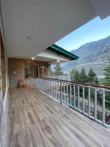 a balcony of a house with a view of a mountain at Cloud 9 Chalet in Manāli