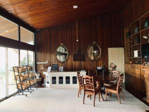 a dining room with a table and chairs and mirrors at 3 Retro-Antique Inspired Interconnected Family Rooms at Country Lodge - Eco Valley Retreat 豐之谷 in Tawau +35 photos
