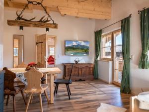 a living room with a table and chairs and a desk at Ferienhaus Weberhof in Hopfgarten im Brixental