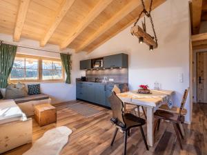 a kitchen and living room with a table and chairs at Ferienhaus Weberhof in Hopfgarten im Brixental