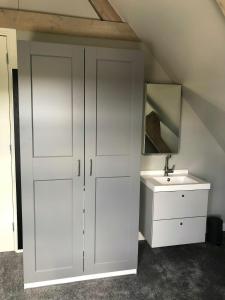 a bathroom with a white cabinet and a sink at welkom bij 5 in Den Ilp